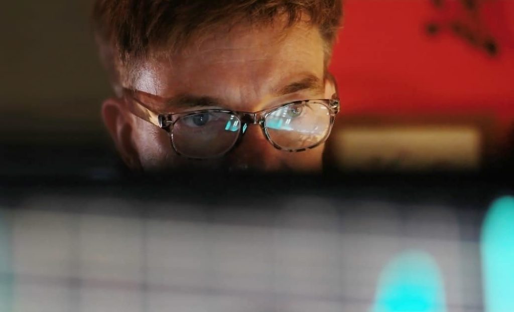 Man looking at computer related to 2021 cybersecurity outlook